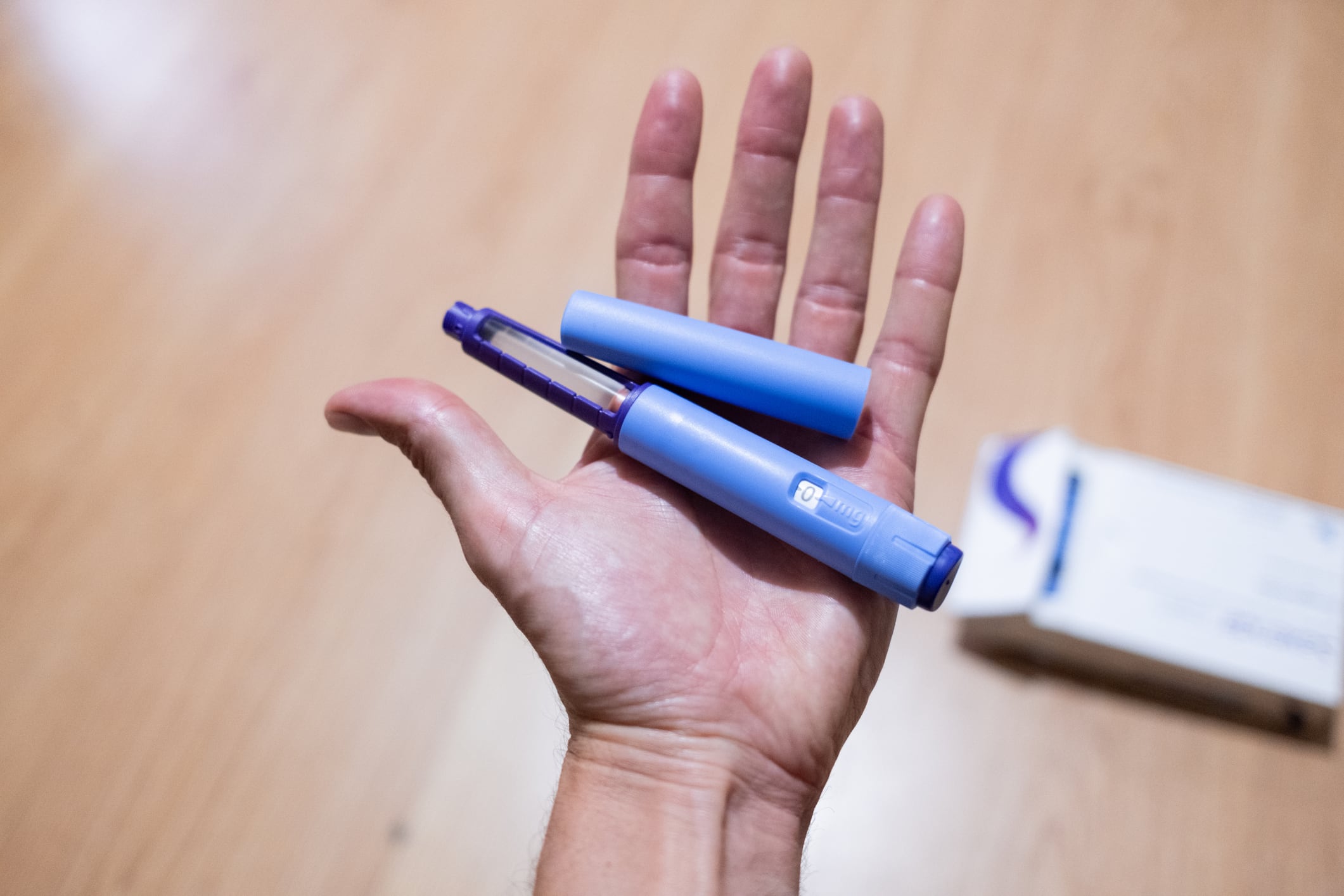 point of view of hand holding semaglutide injection pen as a medical treatment for the prevention and control of overweight, obesity and diabetes.